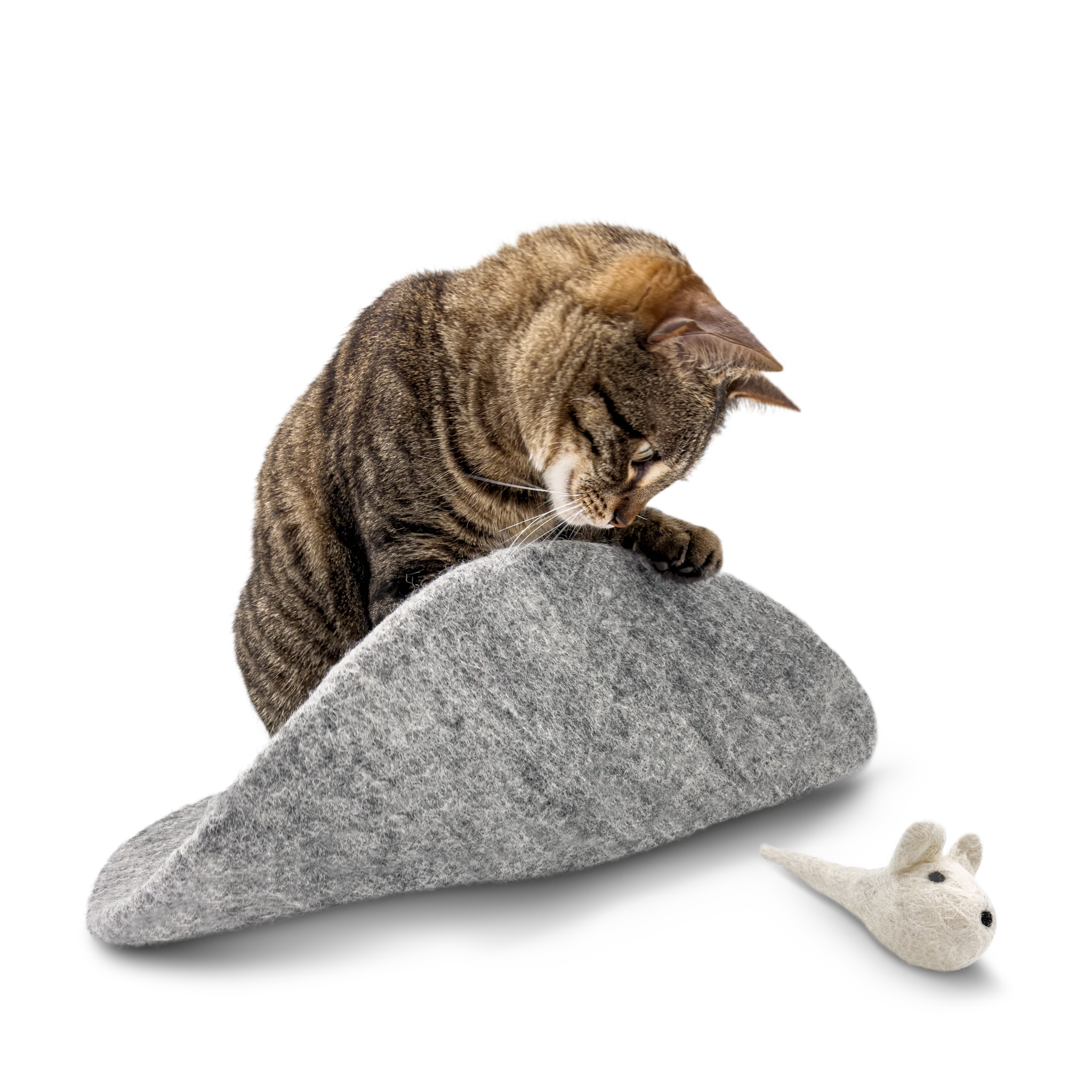 Tabby cat playing with a white mouse toy on a round grey felted wool cat bed.