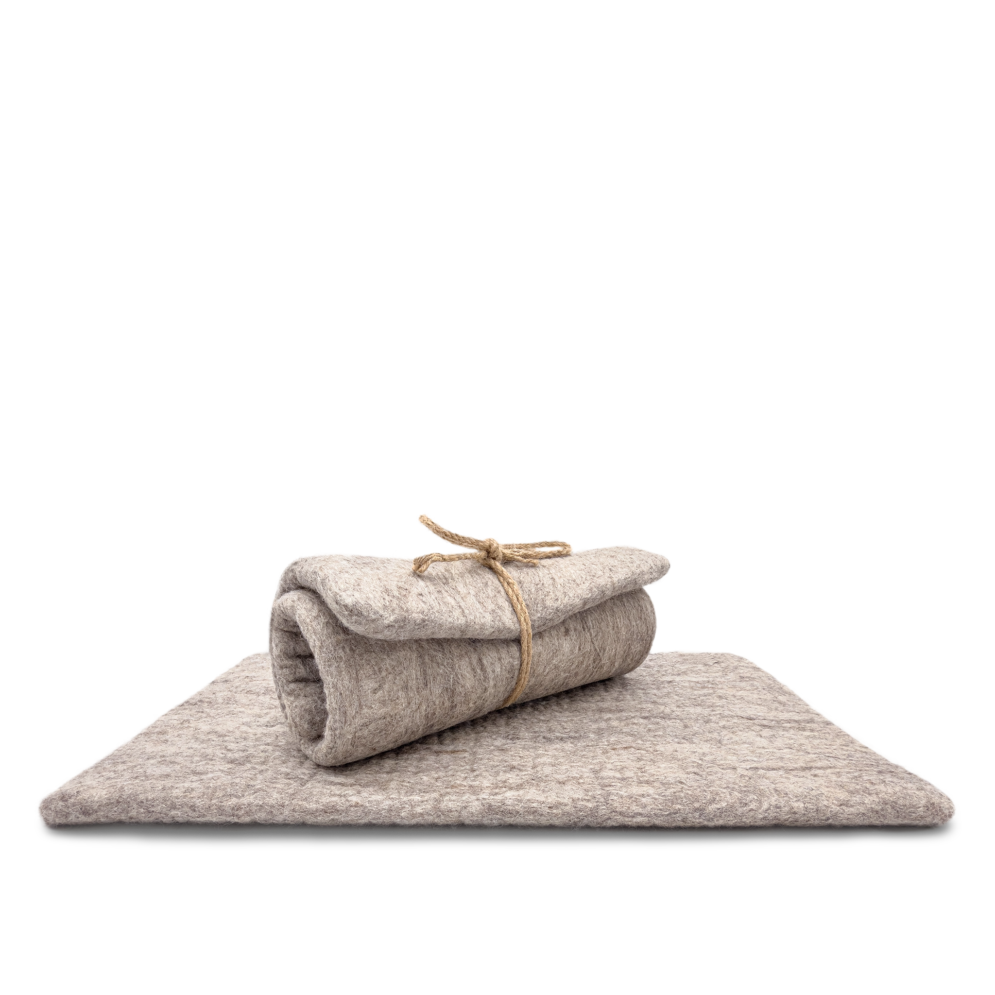 Light brown and grey rectangular felted wool cat carrier cushion rolled and tied with twine on a white background.