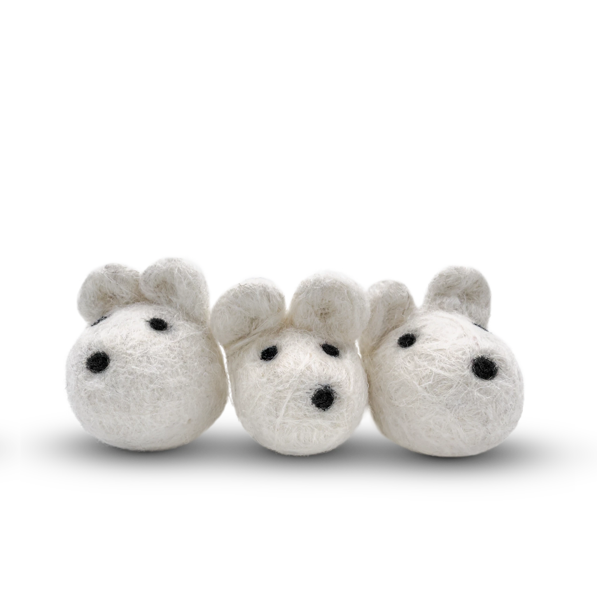 White felted wool mice cat toy on a light background.