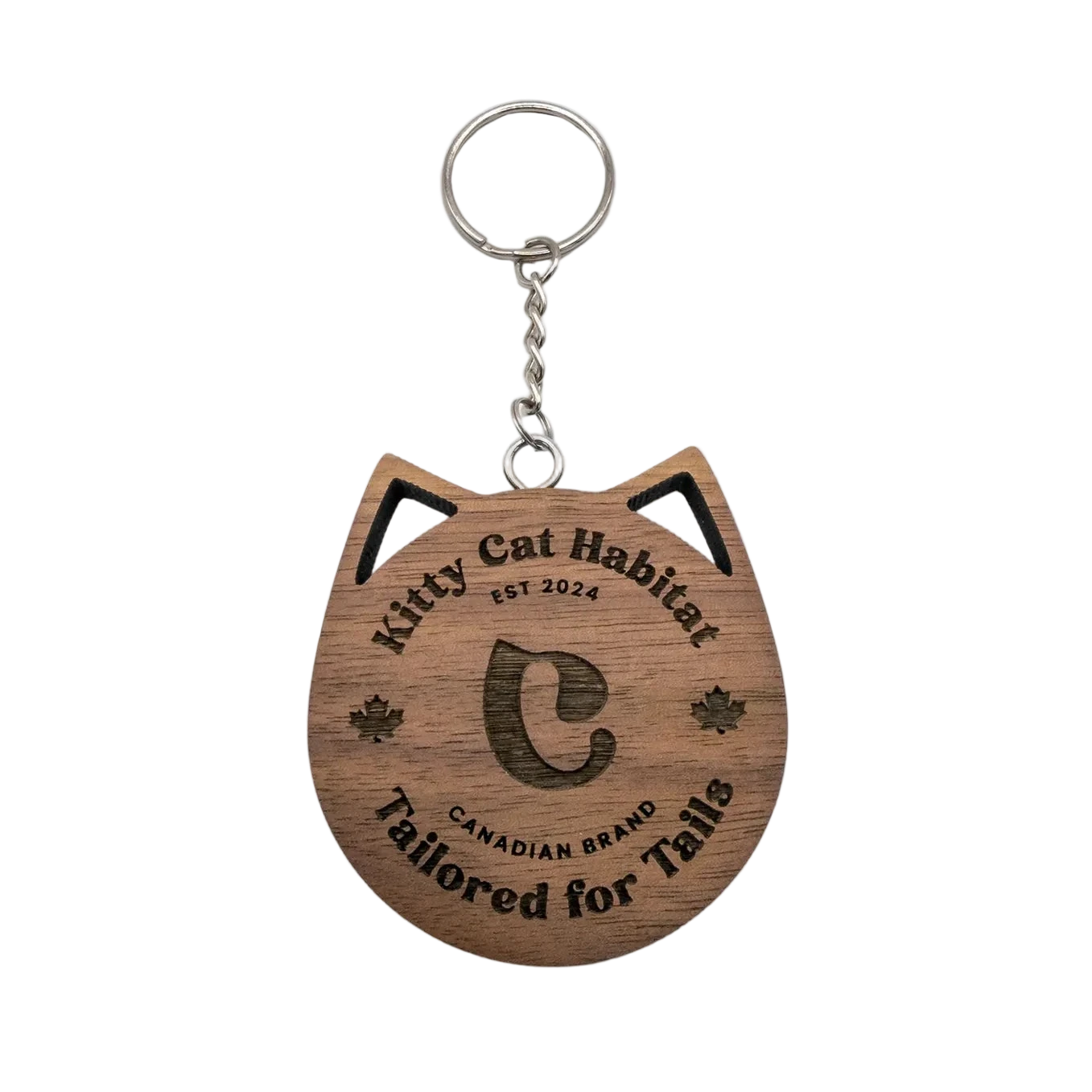 Walnut wooden cat head keychain with Kitty Cat Habitat logo engraving on a light background.
